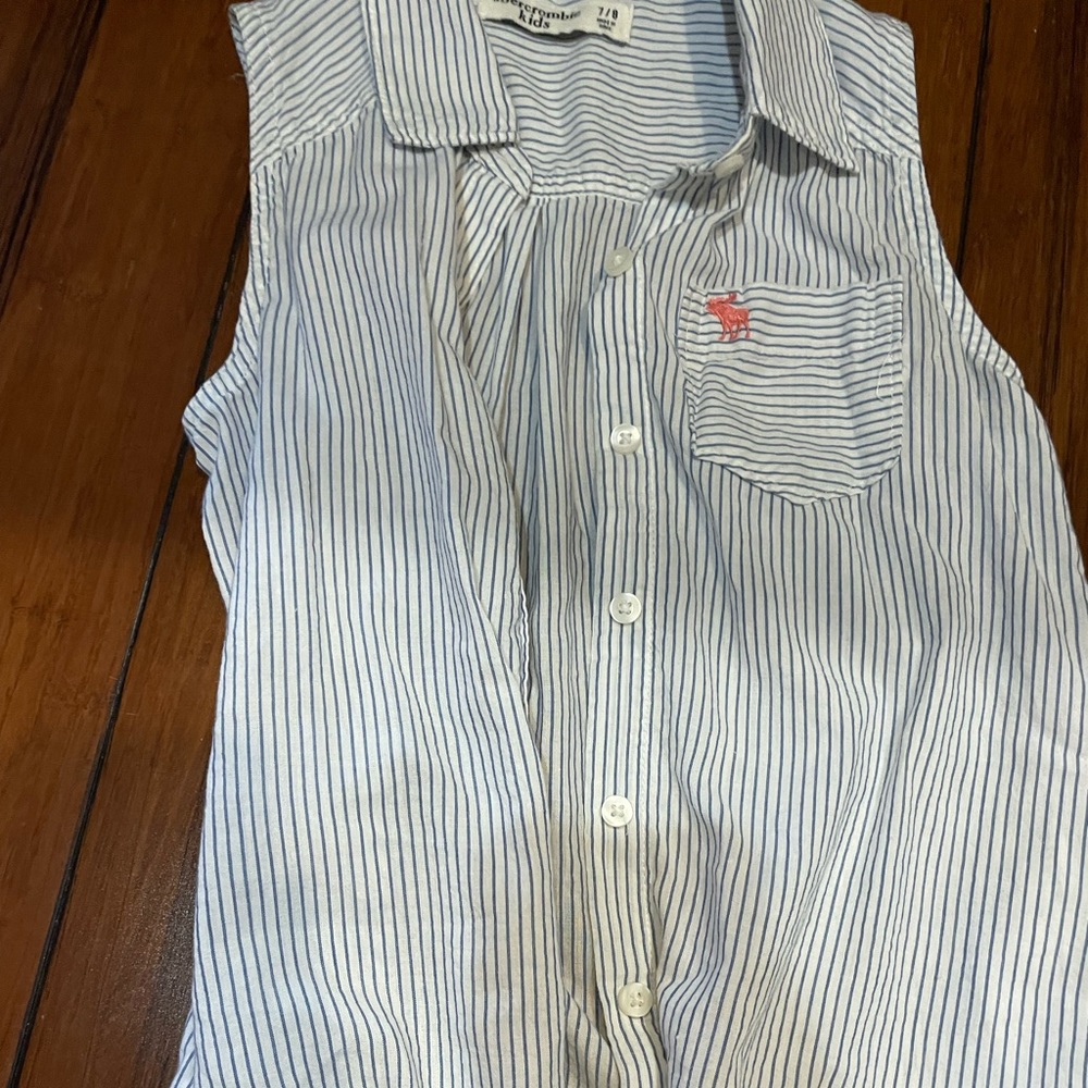 Sleeve less top with blue stripes.